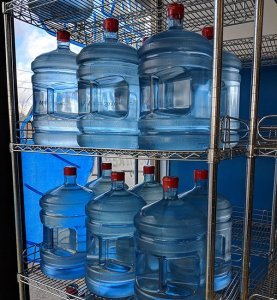 water jugs on rack, drinking water, clean water