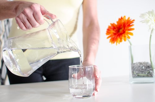 Woman pouring water into glass